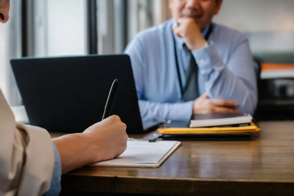 Medical bills and accident paperwork on a desk being reviewed for a settlement demand